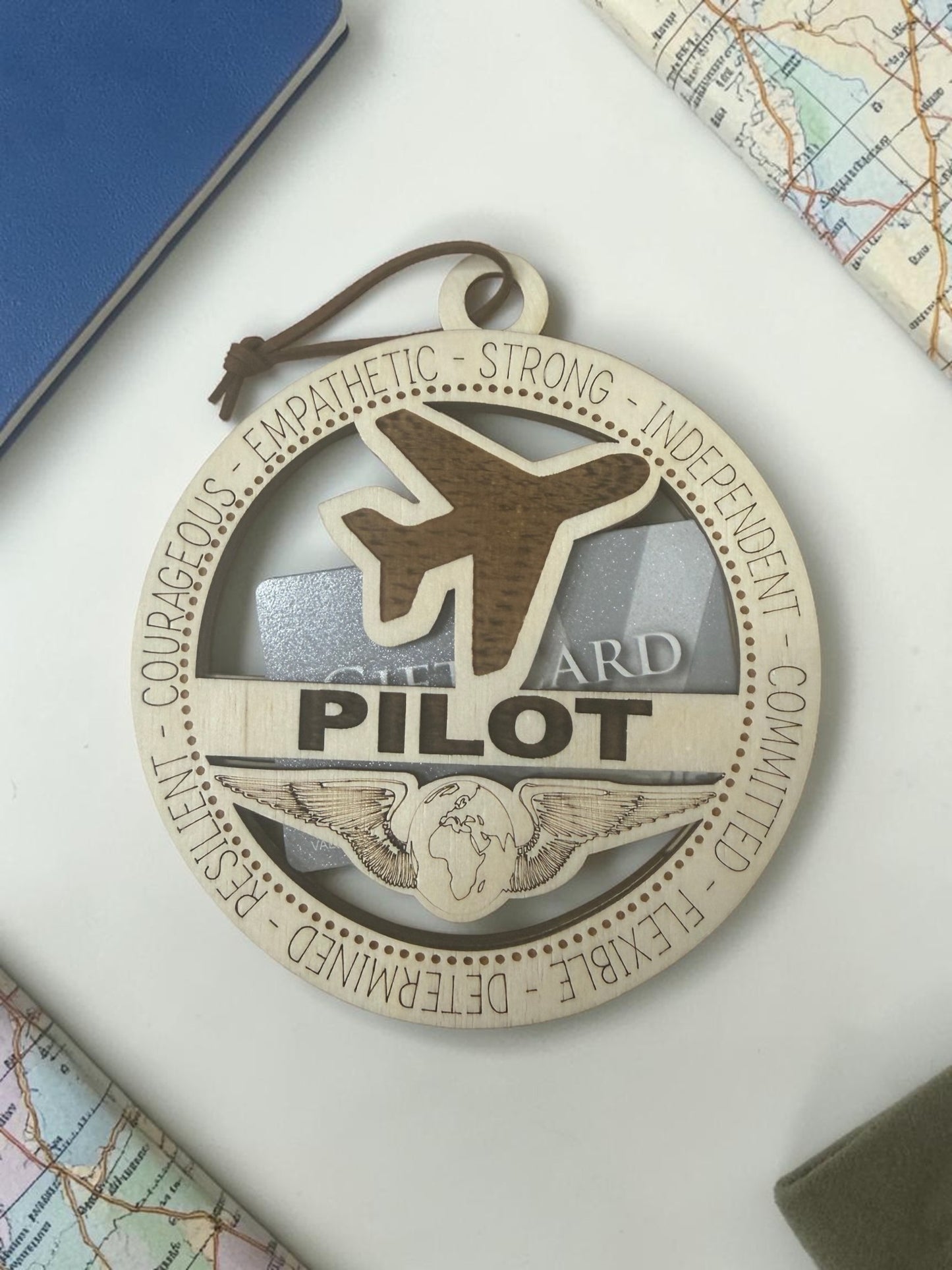 Medal with airplane design and text on a map background