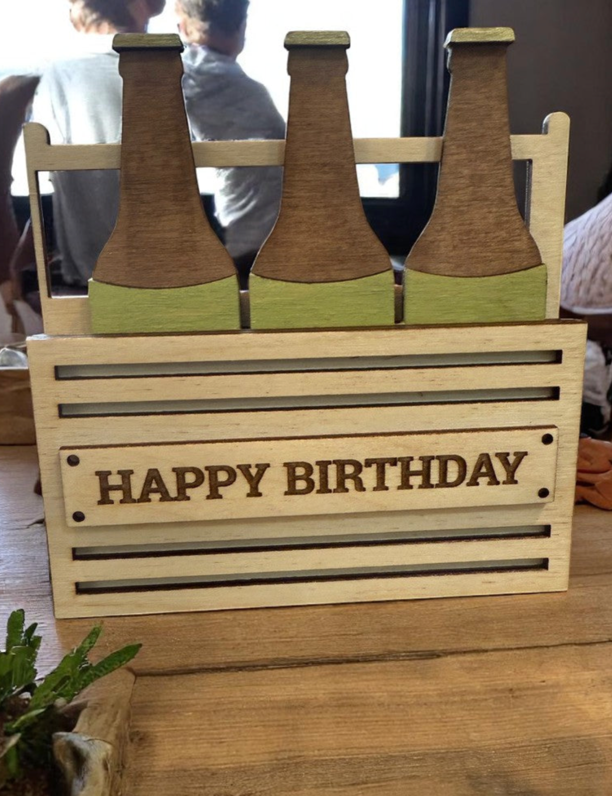Handmade wooden Happy Birthday 6-pack beer gift card holder with birthday design, displayed on a rustic wood background