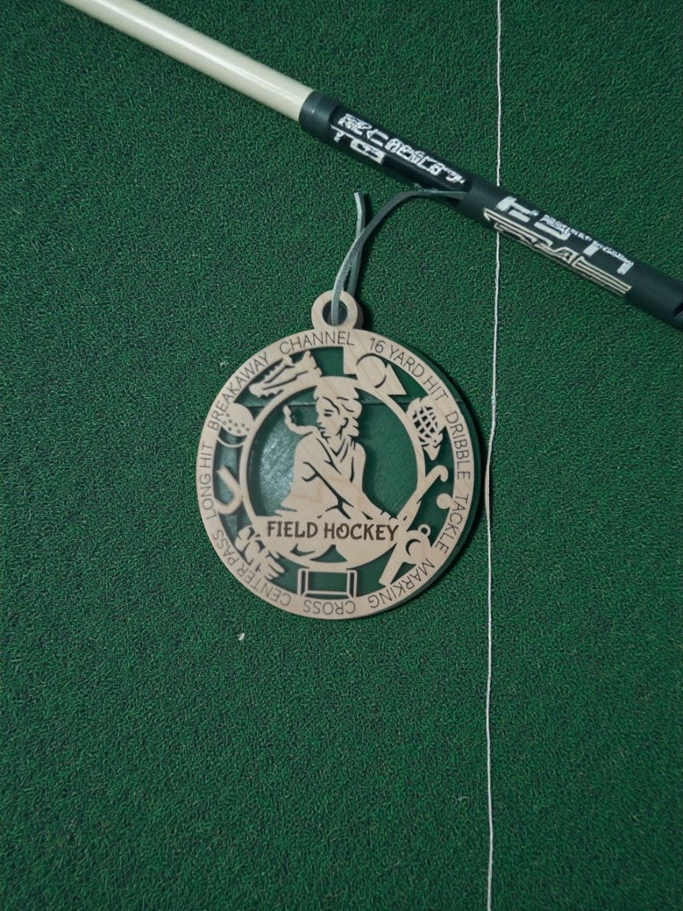 Medal with 'Field Hockey' design on a green background