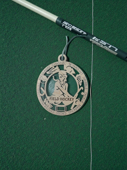 Medal with 'Field Hockey' design on a green background
