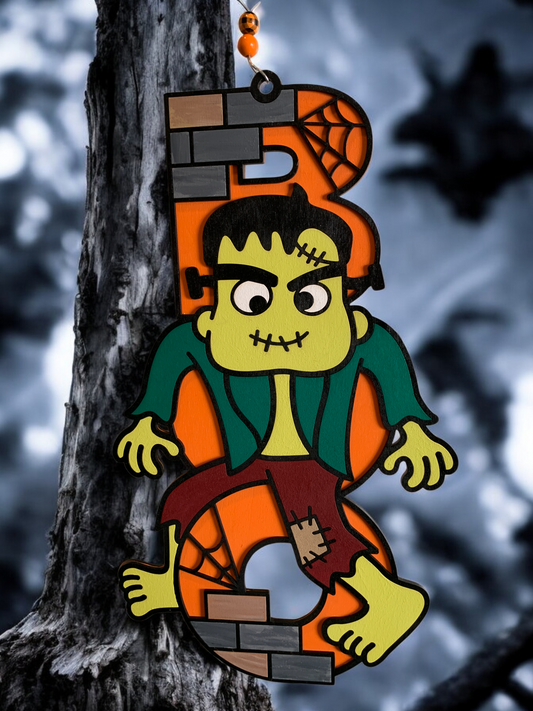 Hand-painted wooden sign featuring a cartoonish Frankenstein character with a 3D effect, designed for Halloween decoration.