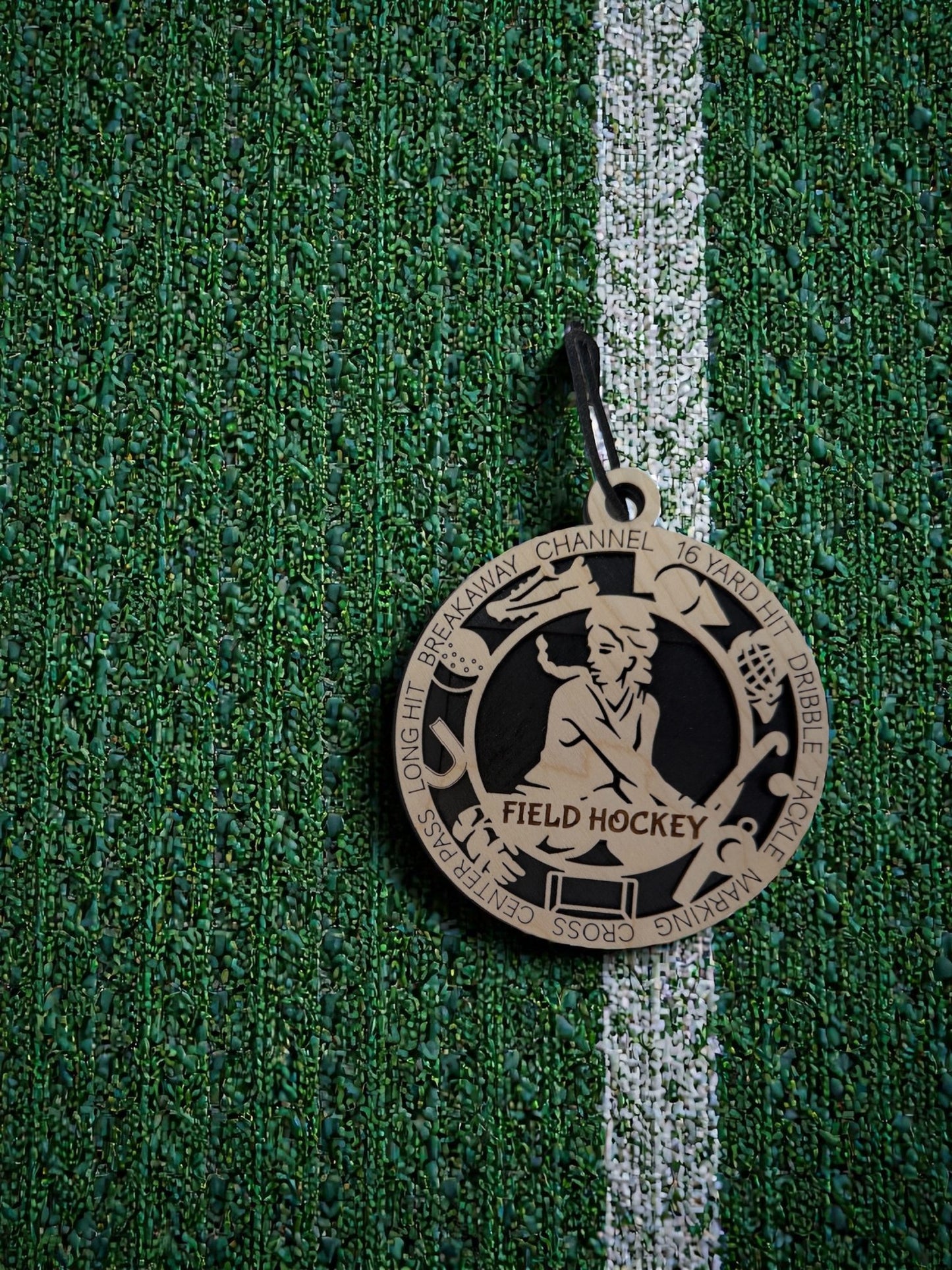 Medal with 'Field Hockey' on a green textured background