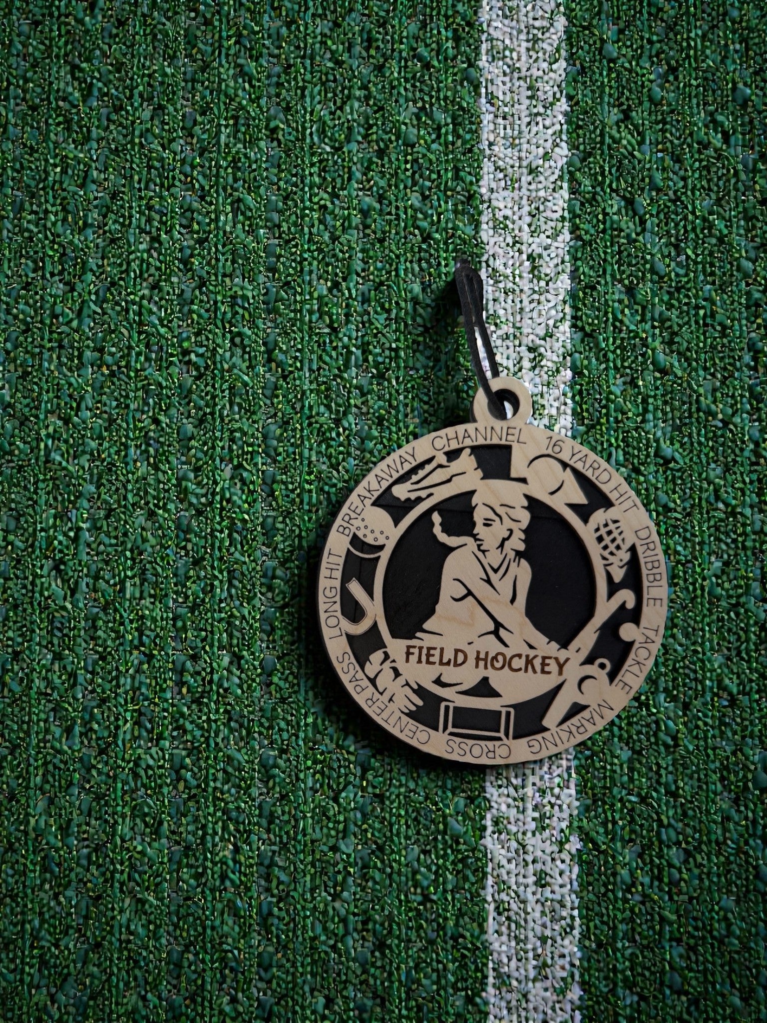 Medal with 'Field Hockey' on a green textured background