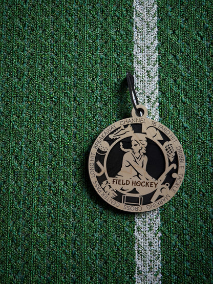 Medal with 'Field Hockey' on a green textured background
