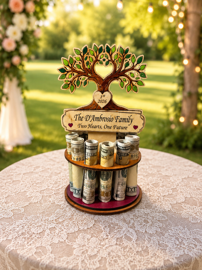 Premium handmade wood tree of life money tree with hand-painted green leaves, heart-shaped trunk cutout personalized with "1st 2026," and Congratulations banner, displayed on a single-tiered base holding 12 rolled bills, styled outdoors with a white rose garden and wedding arch in the background