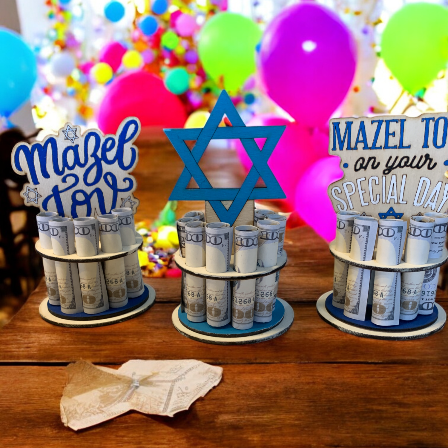 Mazel Tov Bar Mitzvah Money Trees — handmade wooden cash gifts with Star of David toppers and rolled bills, displayed at a colorful balloon celebration